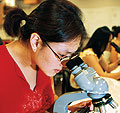 Photo: woman using microscope