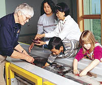 Docents and children at seawater table.